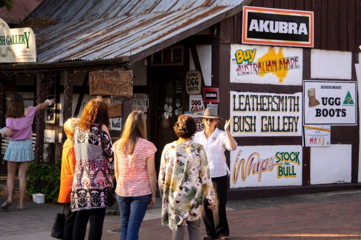 a group of people standing in front of a store