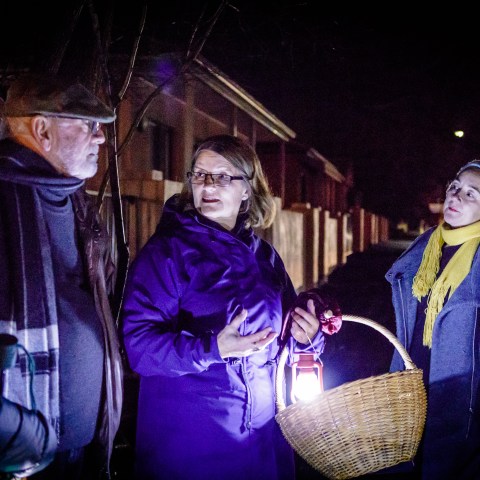 Shannon leading a tour group at night
