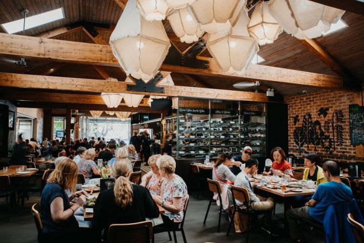 a group of people sitting at a table in a restaurant