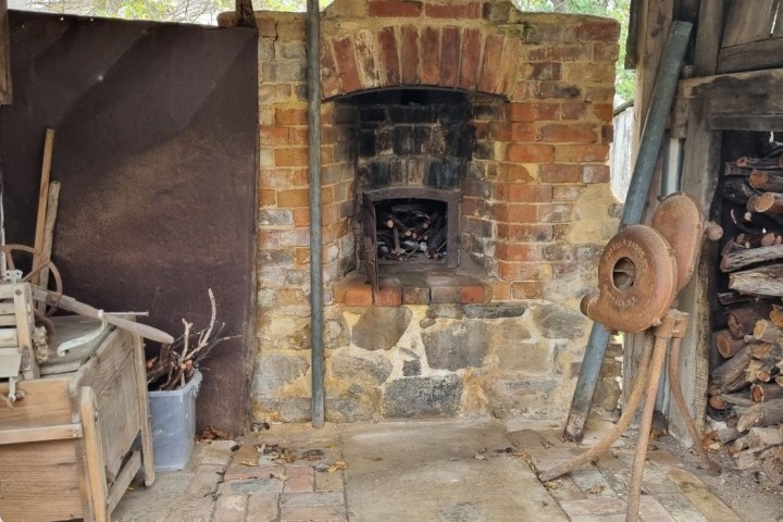 an old brick building next to a fireplace
