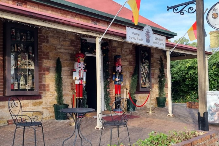 Exterior of the German Village Shop with nutcracker figures and flags on display.
